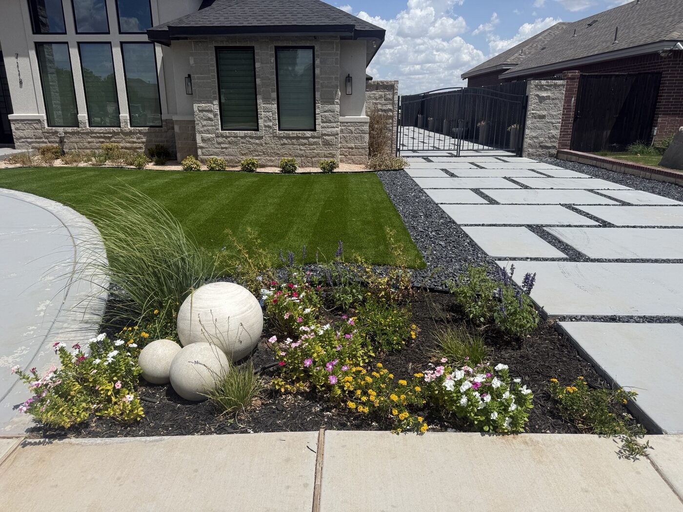 Colorful garden bed beside a finished front lawn